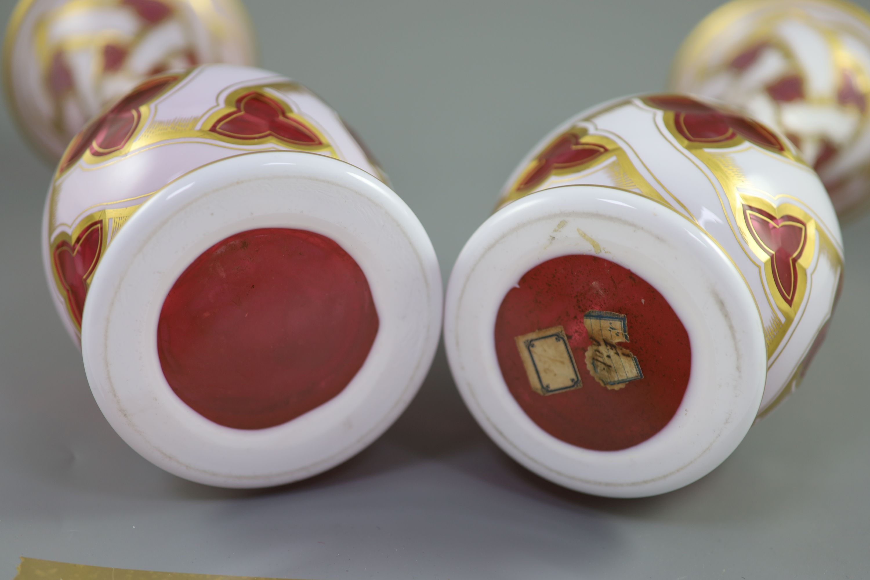 A pair of Bohemian white and ruby overlaid glass baluster vases, late 19th century, 34cm high